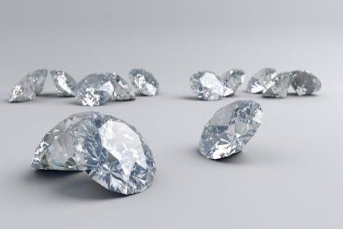 13 large, cut diamonds arranged on a light surface