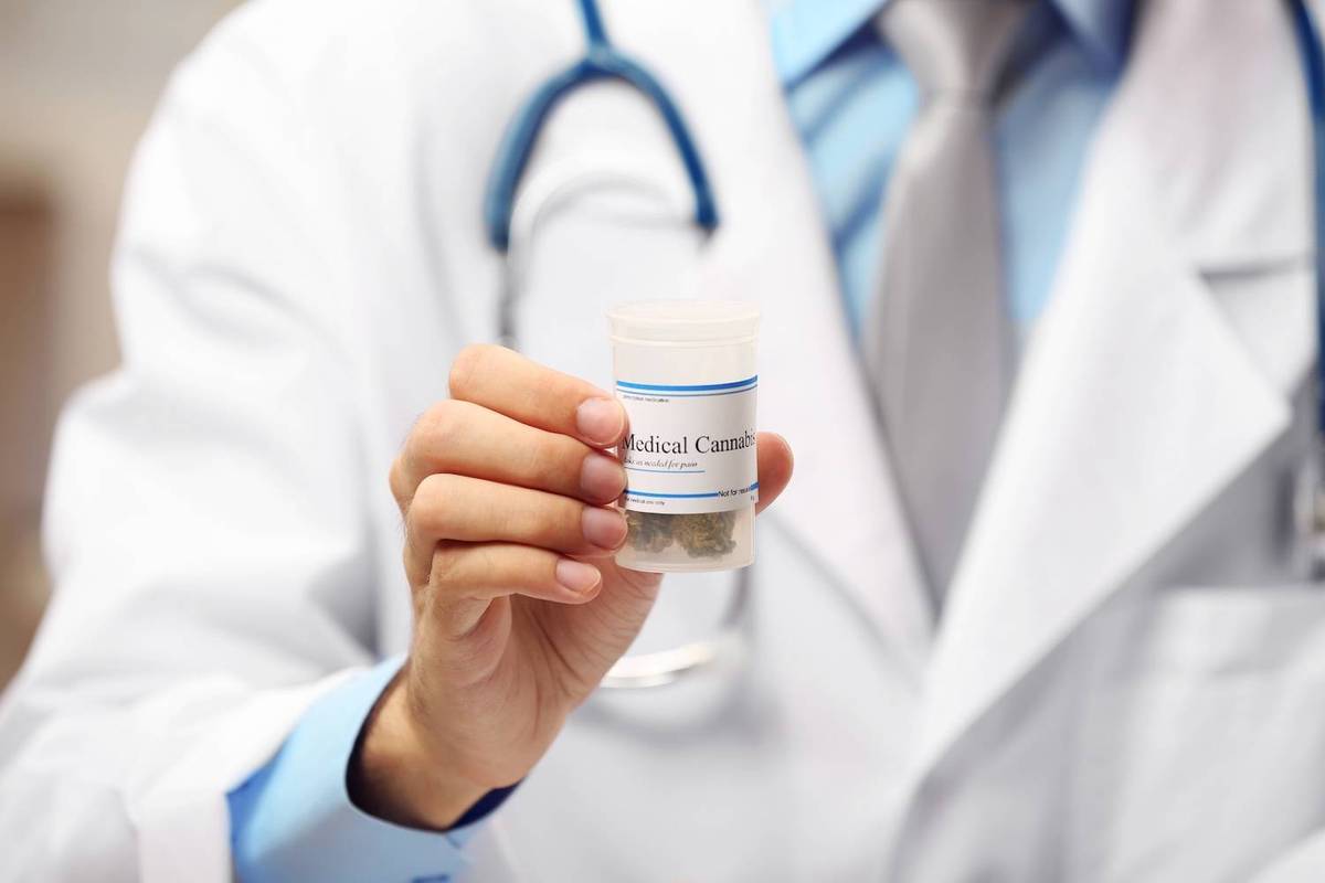 A doctor in a white coat holds a medical cannabis container; text reads: Medical Cannabis.