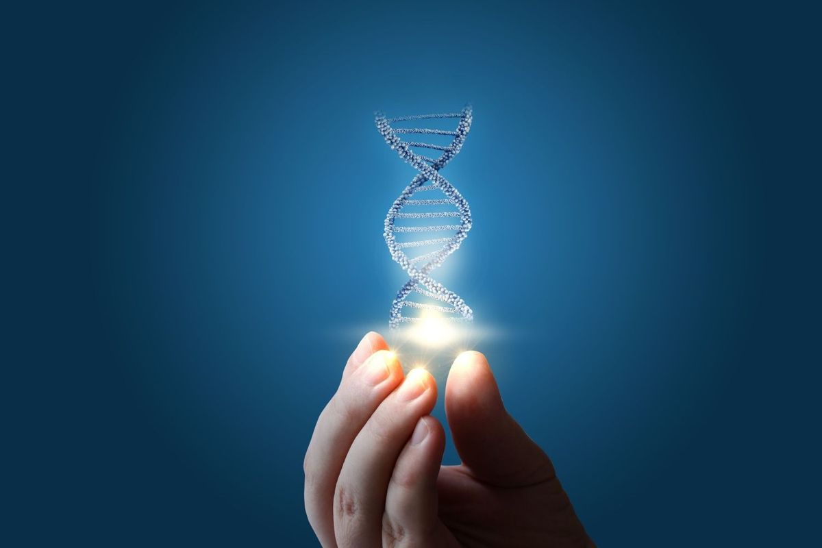 A floating DNA double helix above a hand with a blue background.