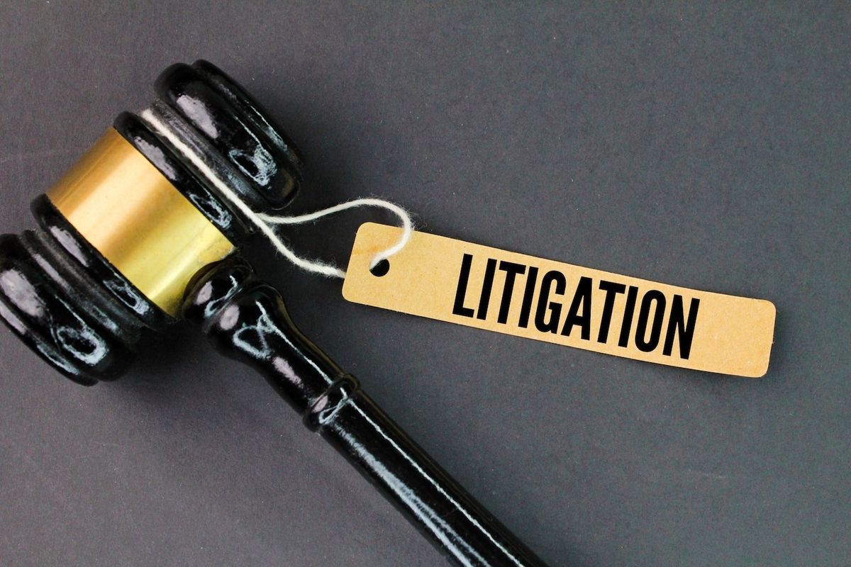 A gavel with the word "litigation" beside it.