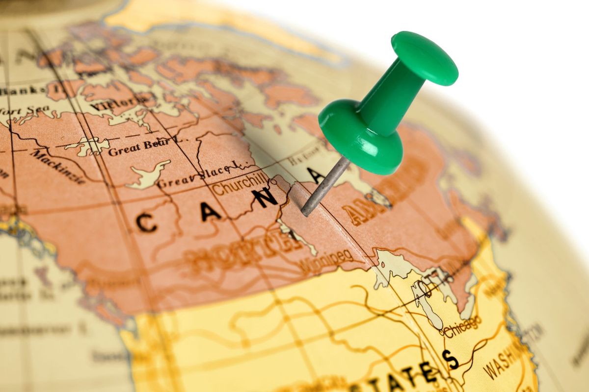 A green pushpin marks a location on a map of Canada.