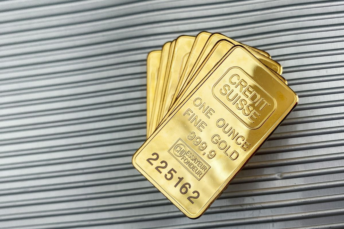 a group of gold bars sitting on top of a metal wall