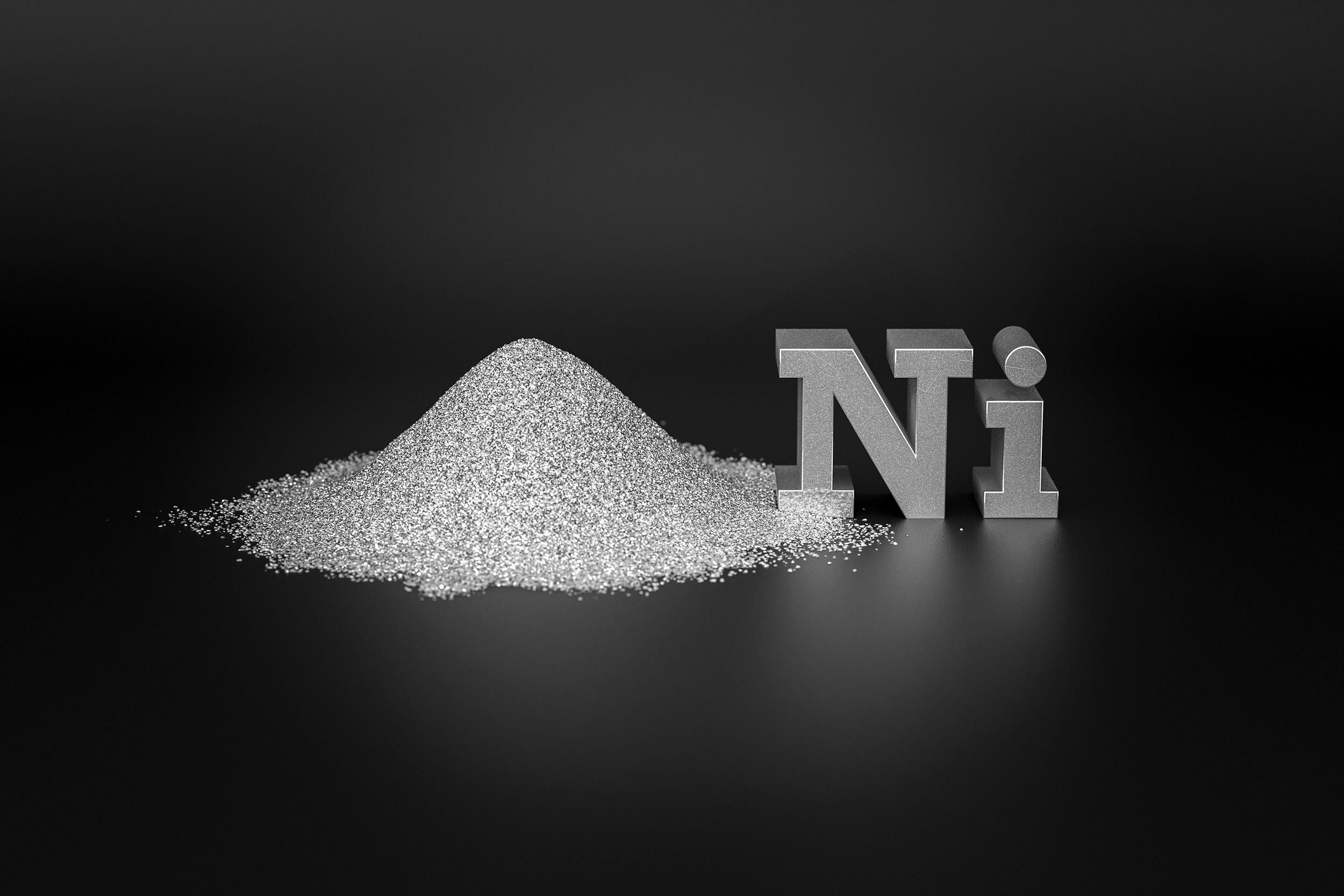 a handful of silver-white nickel metal powder and the chemical symbol for nickel on a black background