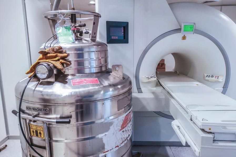 a helium tank beside an MRI machine