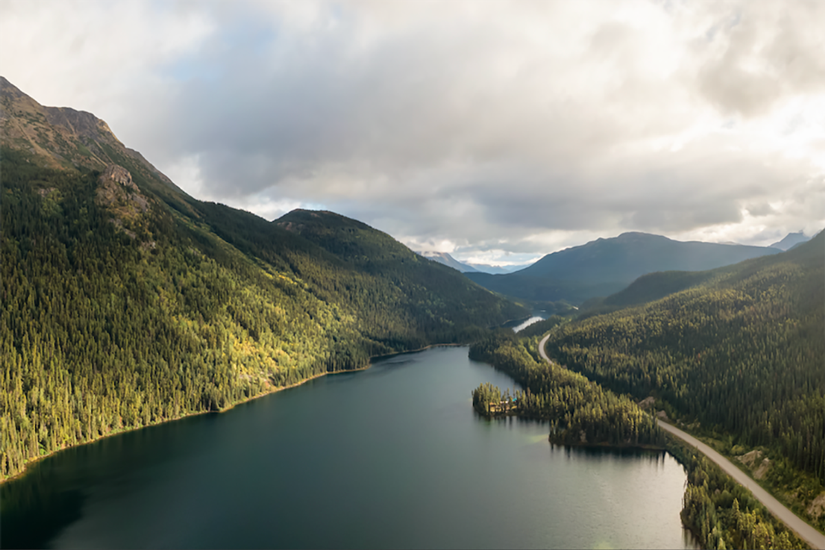 a lake in between treed mountains