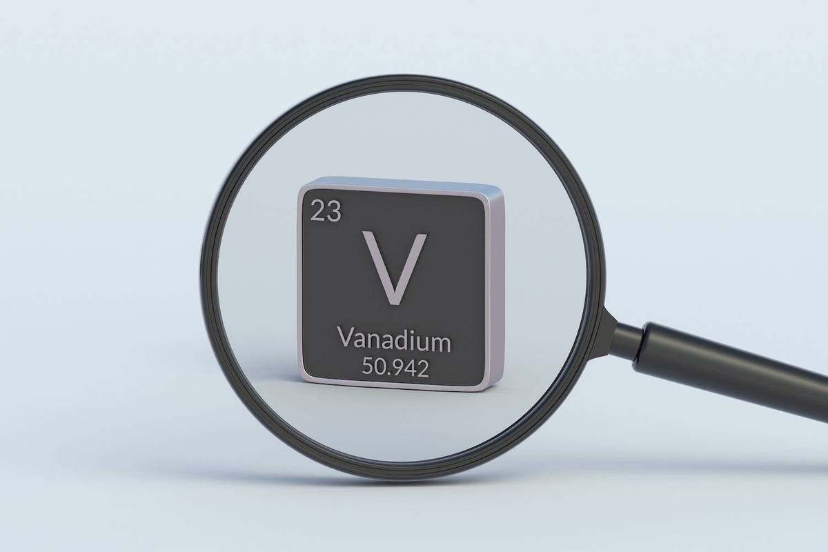 A magnifying glass focuses on a gray Vanadium element block; Text reads: "23 V Vanadium 50.942".