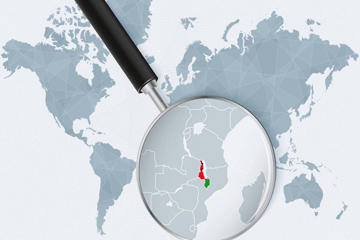 A magnifying glass highlights an African map region in green and red over a world map background.