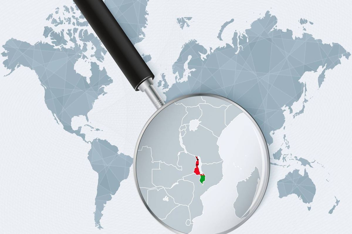 A magnifying glass highlights the African country of Malawi in green and red over a world map background.