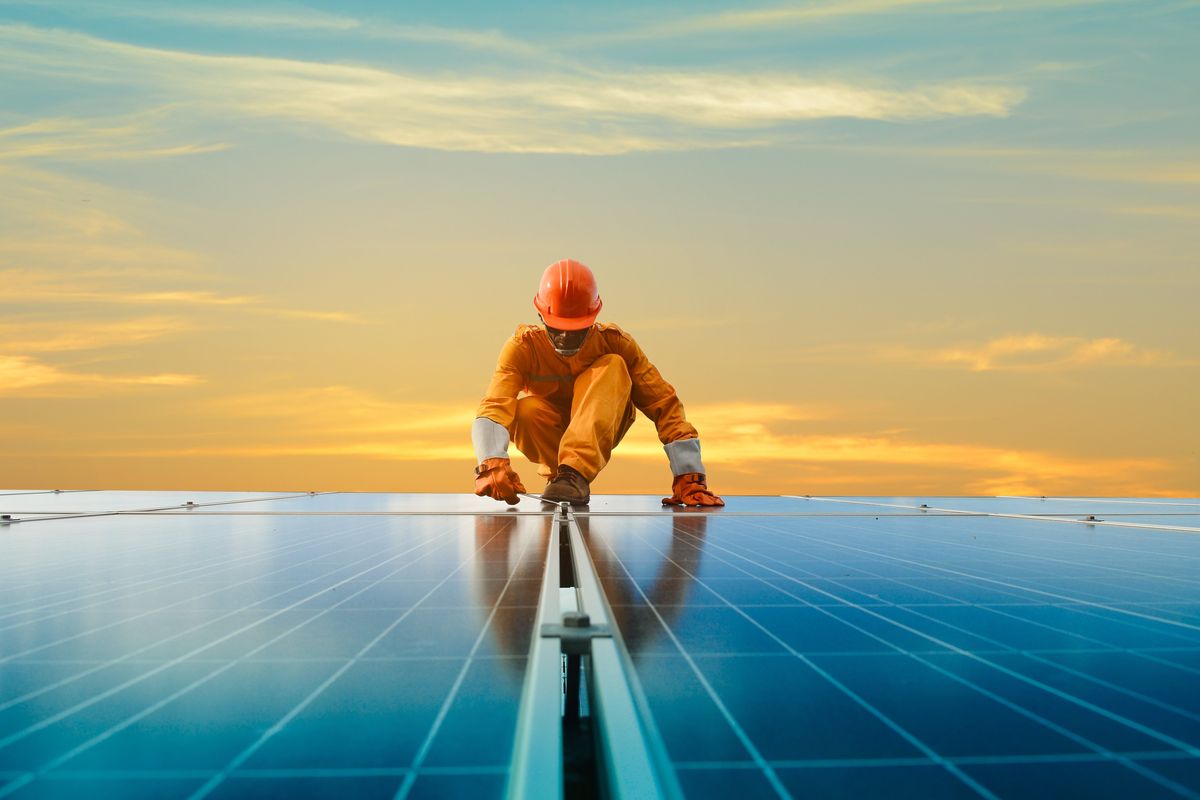 A man working at solar power station.