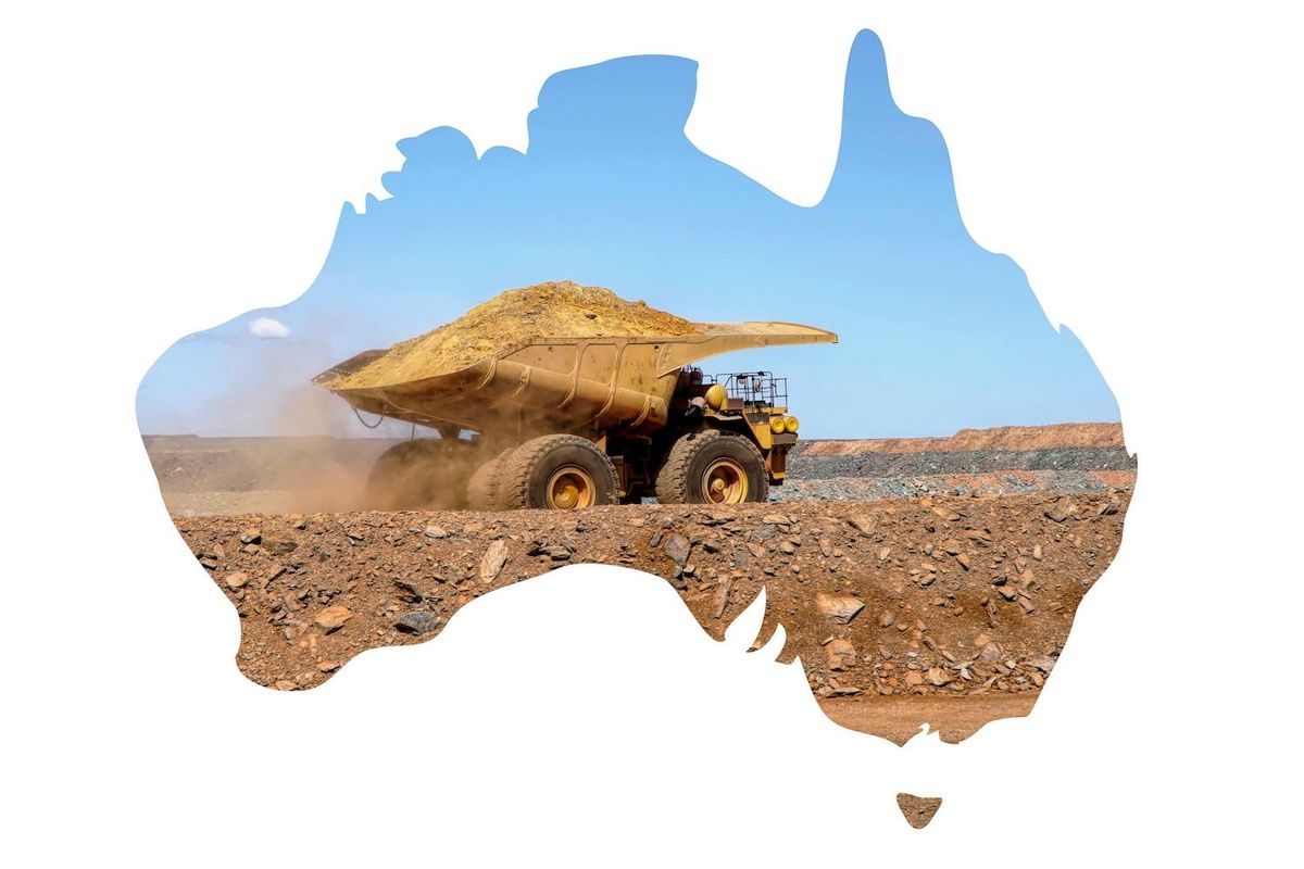 A mining truck within the outline of Australia's map on a clear day.