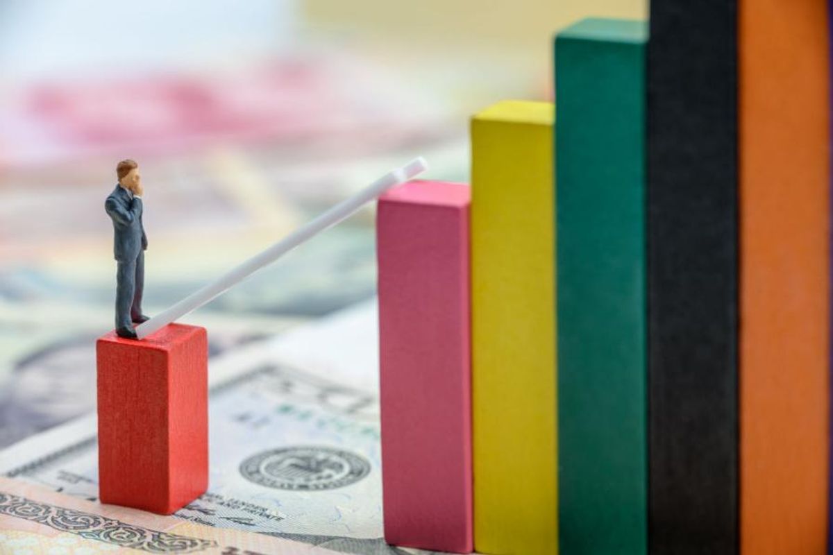 a small figure stands on top of a block thinking of a way to jump to next adjacent block