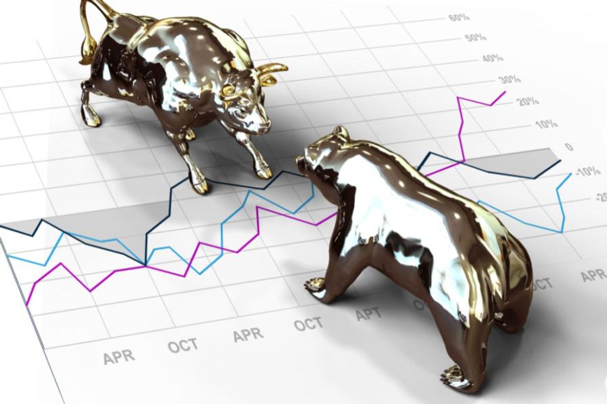 a small silver bull and small silver bear face off on top of a year chart