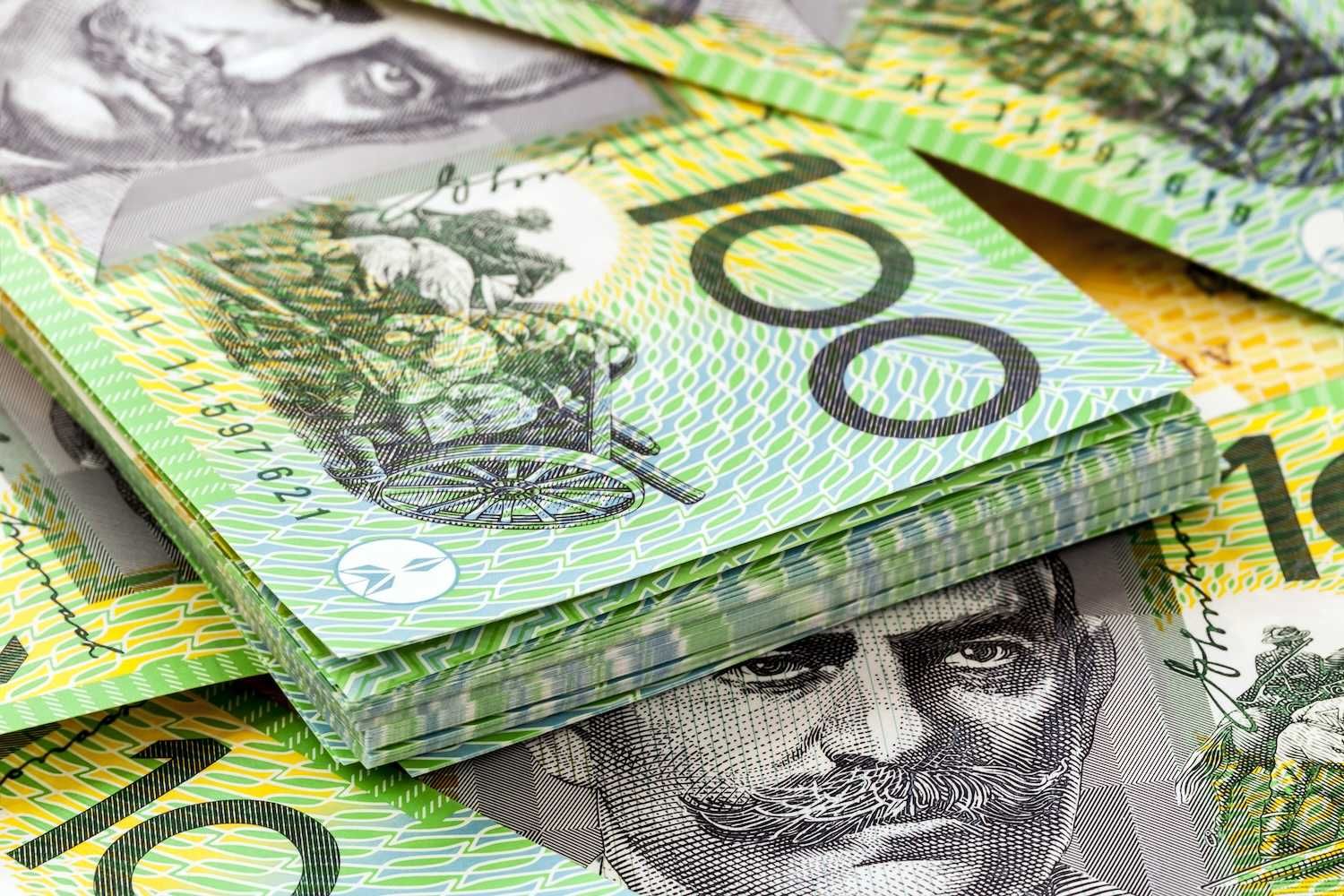A stack of Australian 100 dollar banknotes in close-up.