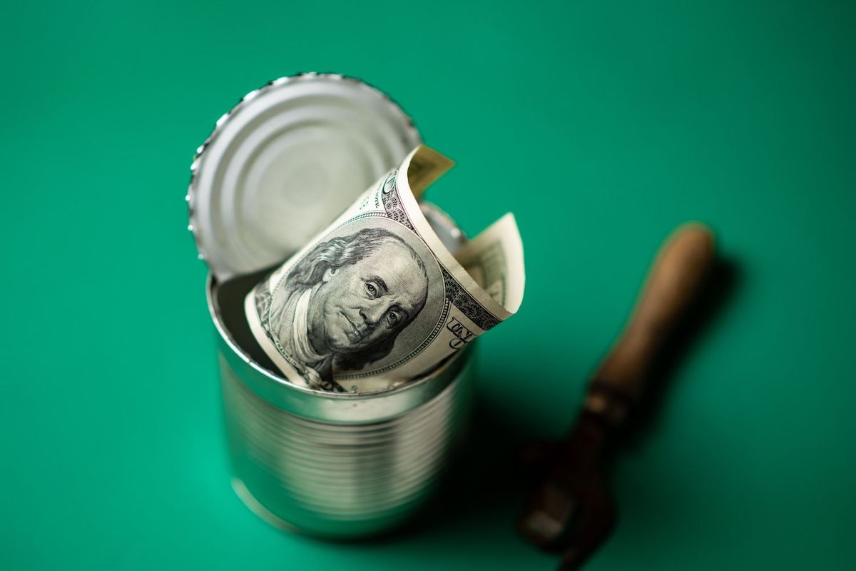 A tin can with a US bill inside.