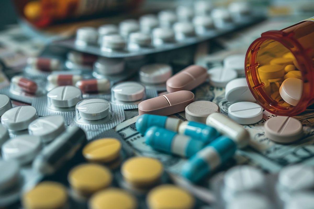 A variety of pills on top of US money.