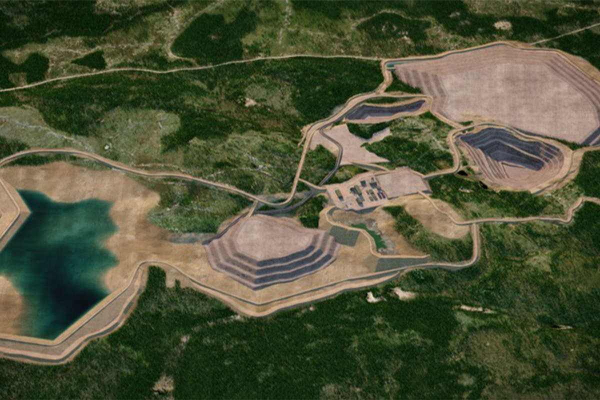 Aerial view of a mine site with terraced pits surrounded by forest.