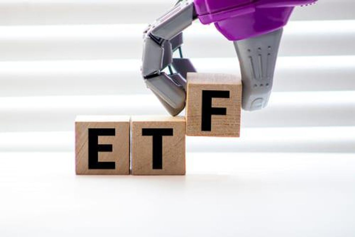 alphabet blocks reading E and T are on a table; a robot's hand places an F block next to them