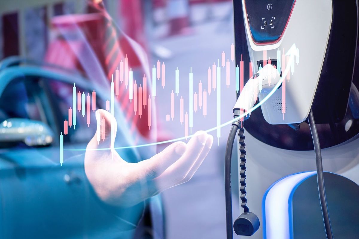 An EV and its charging station on top of a stock chart.