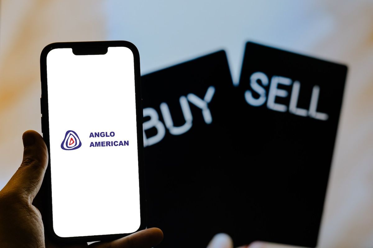 "Anglo American" written on a phone screen with the words "buy" and "sell" behind it. 