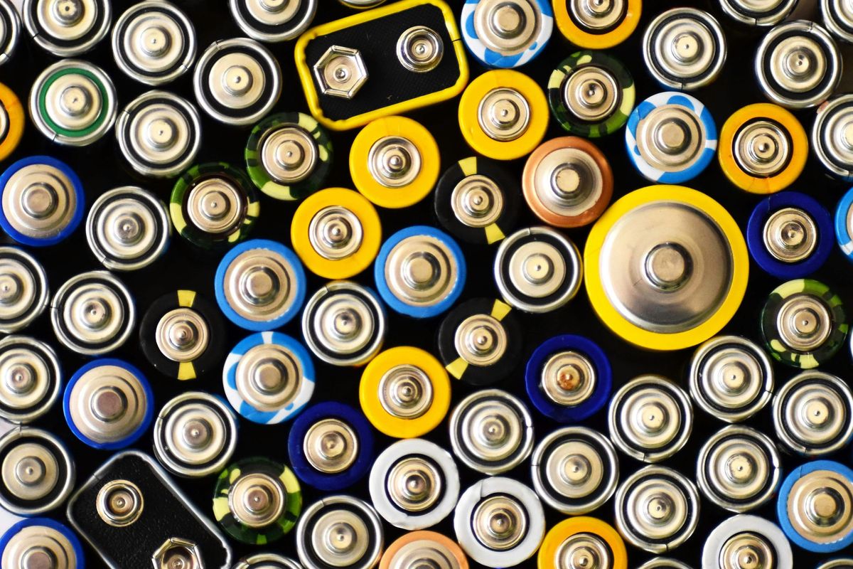 Assorted battery tops in various sizes and colors, arranged closely together.