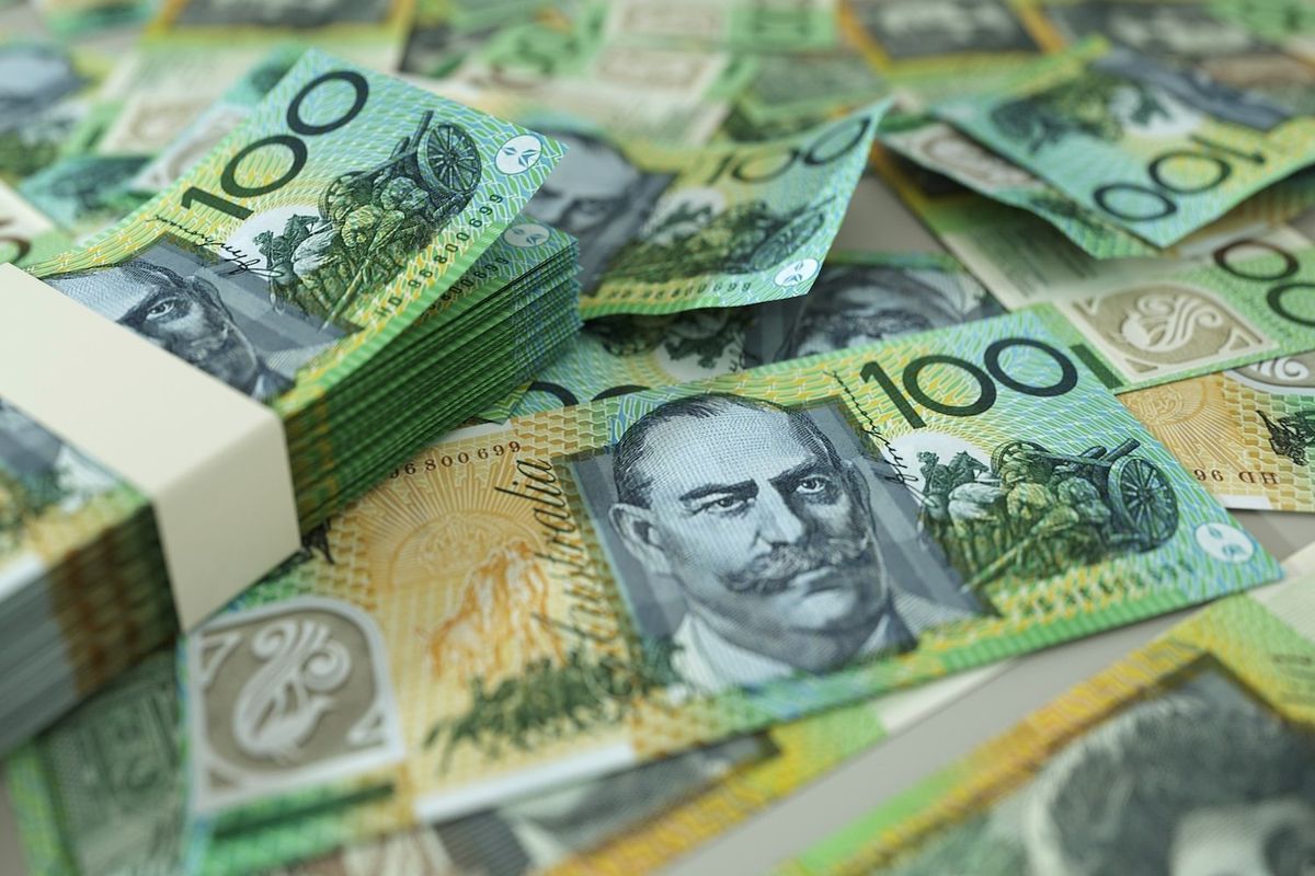 AU$100 notes spread across a table. 