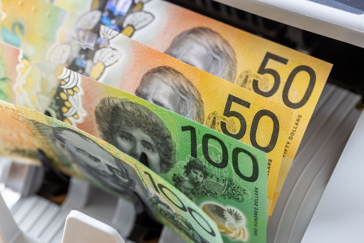 AU$50 and AU$100 notes in a counting machine.