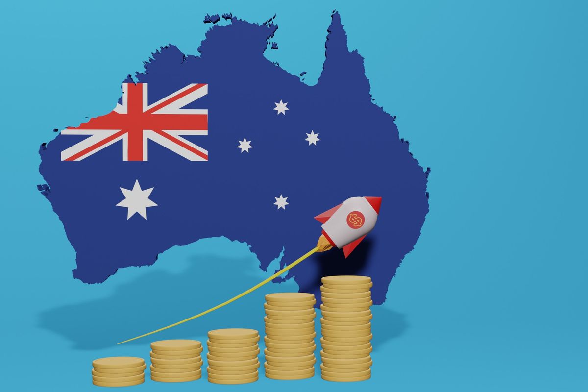Australia flag superimposed on a map alongside stacks of coins and a rocket ship.