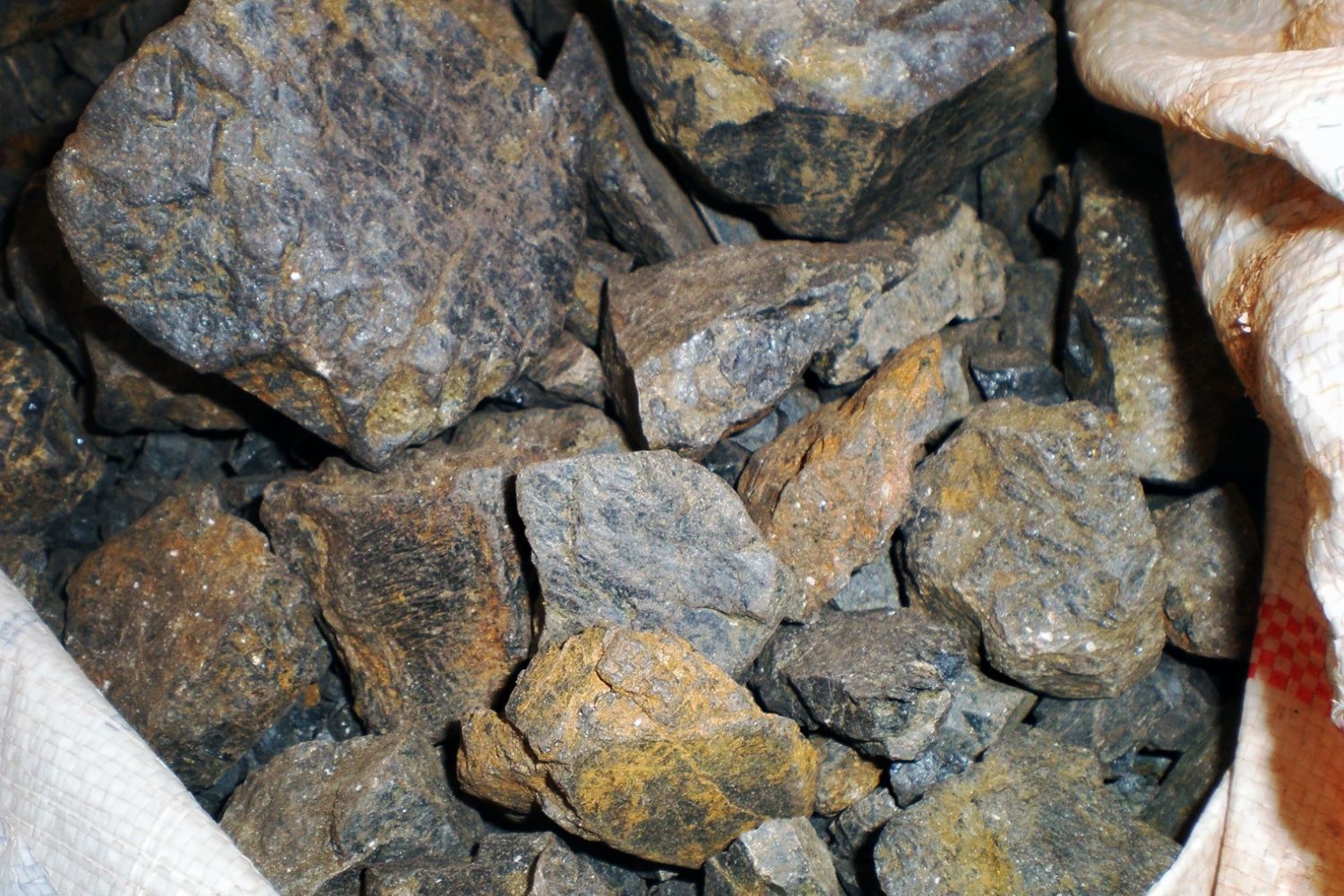 Basket holding many pieces of coltan ore mined in the Democratic Republic of Congo.