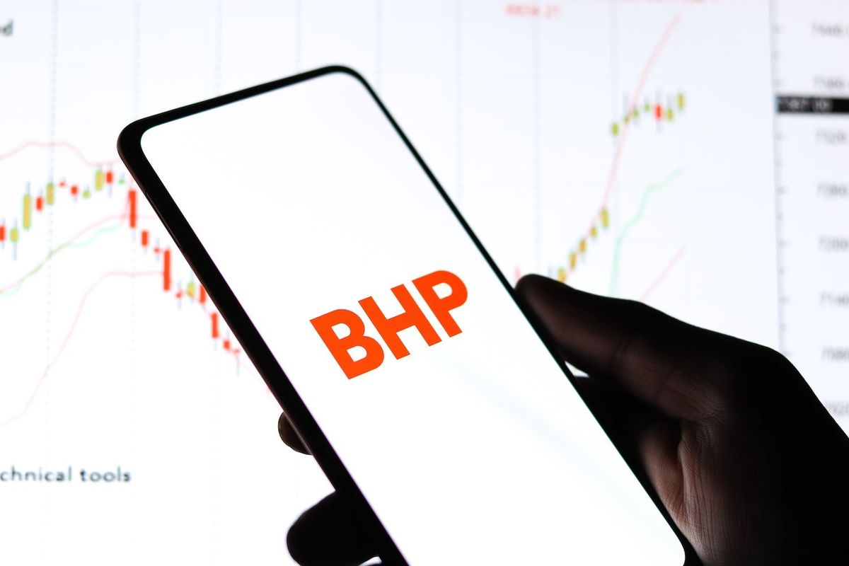 "BHP" on phone screen in front of stock screener.