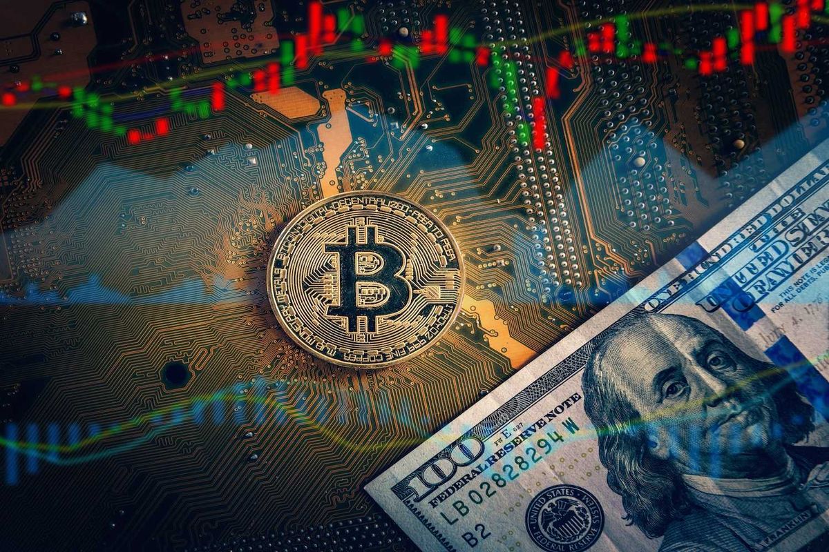 Bitcoi on a circuit board with a US$100 bill and stock market graphs overlay.