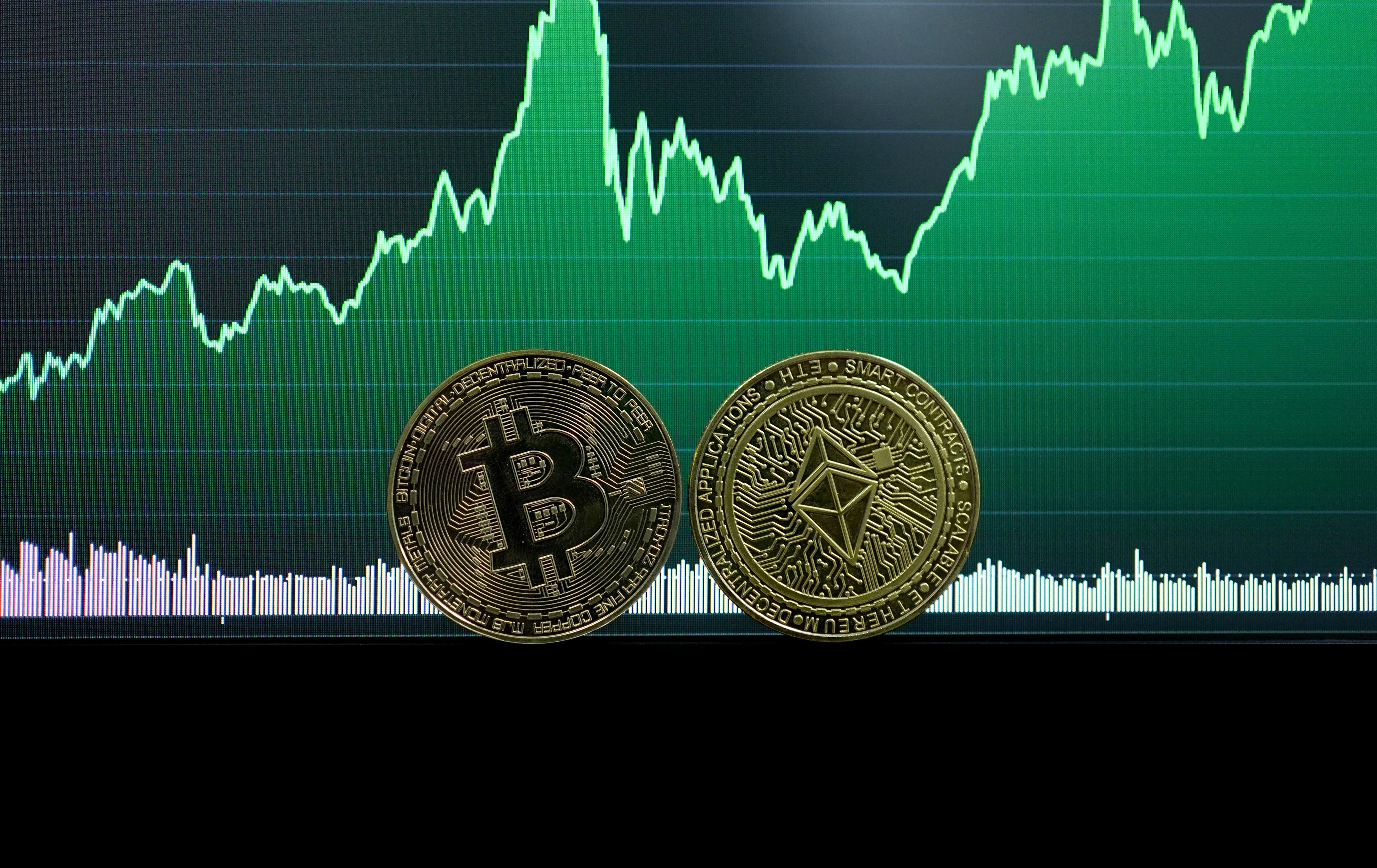 Bitcoin and Ether coins with a green financial graph in the background.