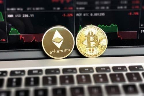 bitcoin and ethereum coins on keyboard