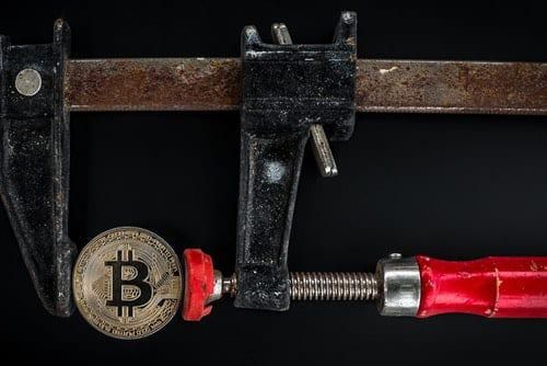 bitcoin being compressed with a vise