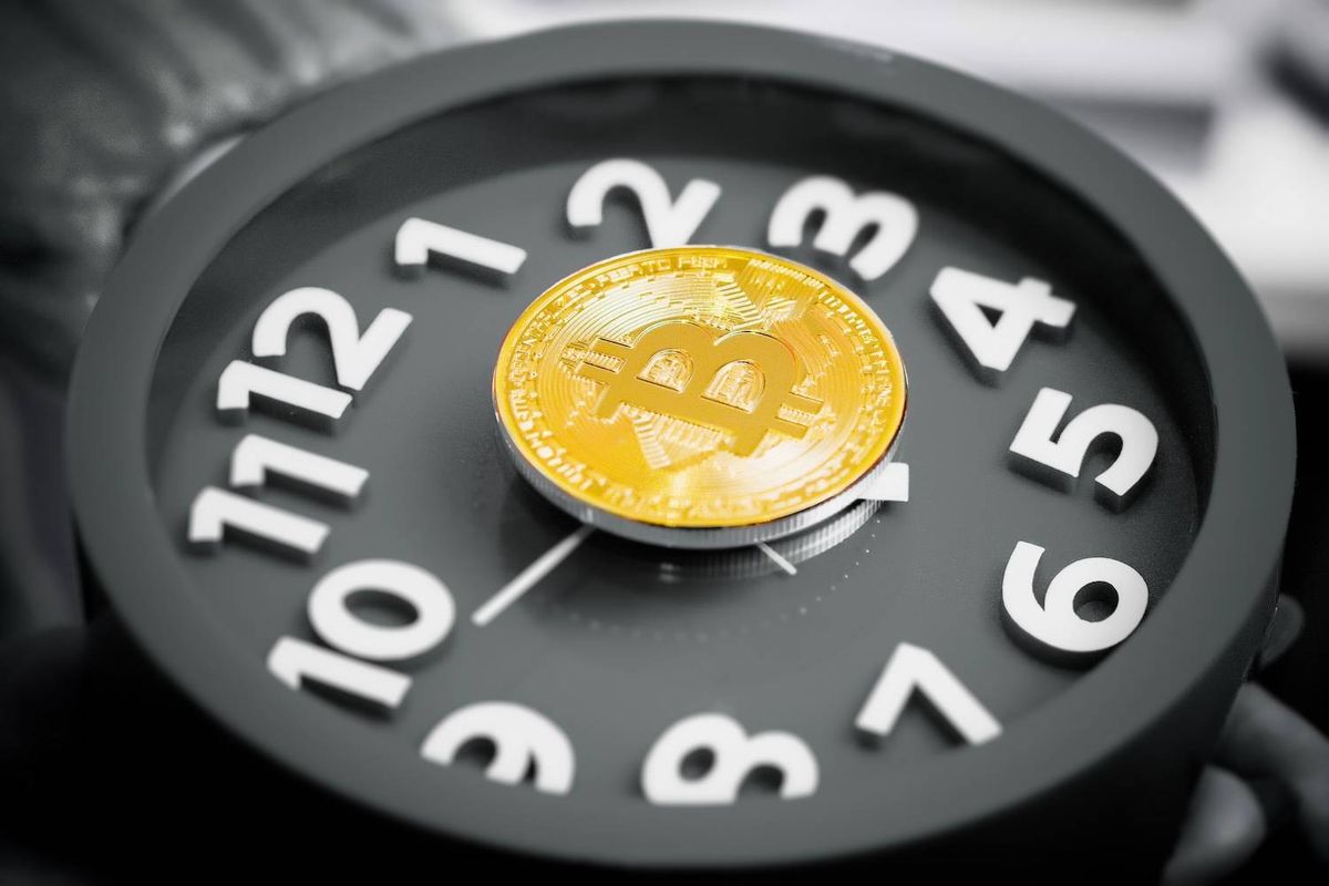 Bitcoin coin on a clock face with white numbers.