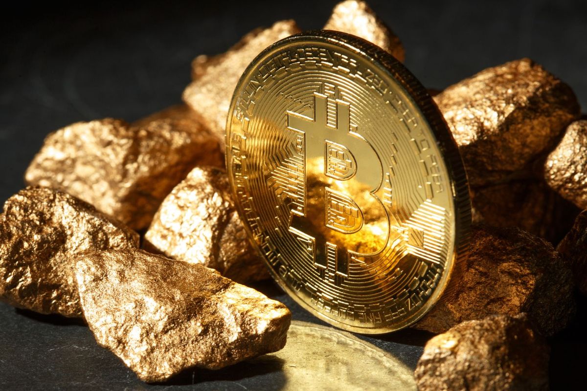 Bitcoin coin with gold nuggets on a dark background.
