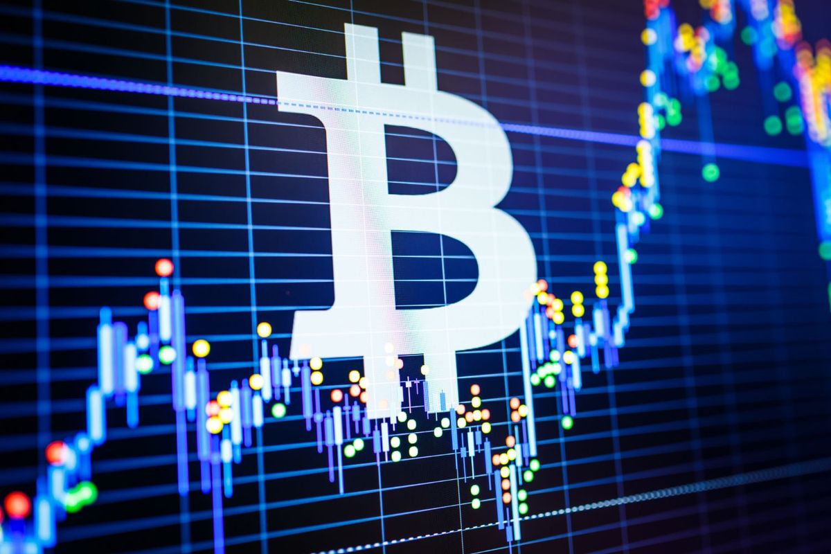 Bitcoin logo overlaid on a colorful financial chart.