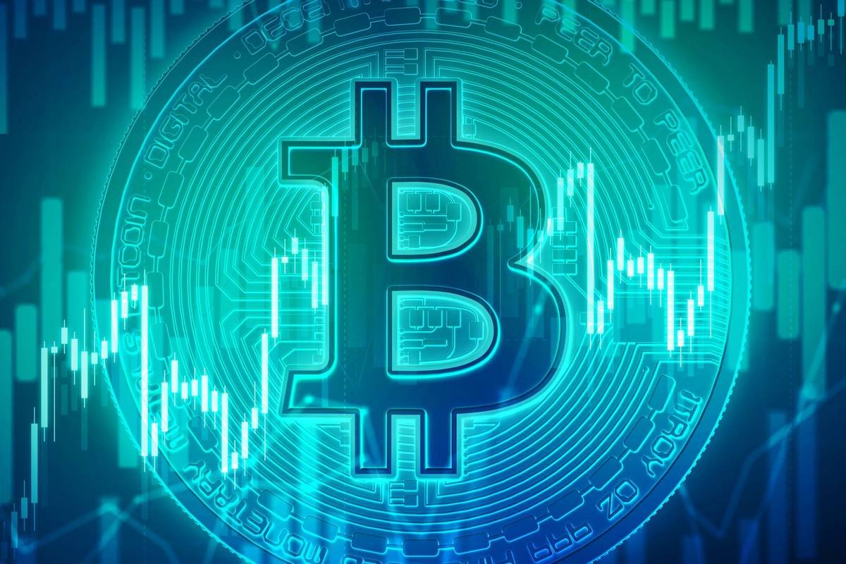 Bitcoin symbol with digital stock market chart background.