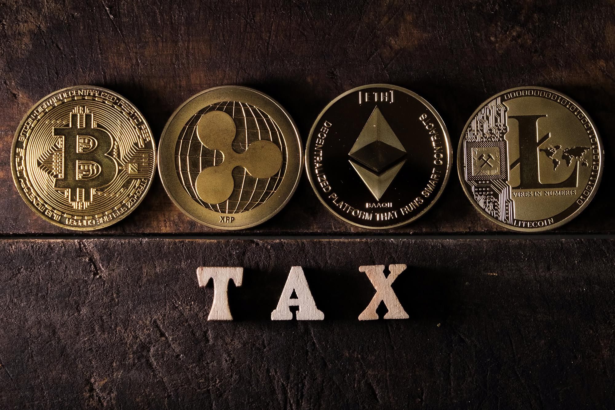 bitcoin, xrp, ethereum and litecoin in front of the word "tax"