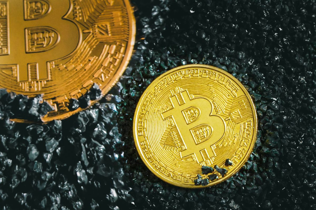 Bitcoins on black rocks.