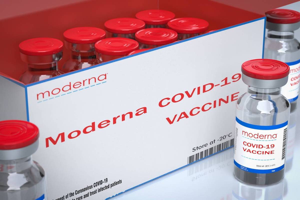Box of Moderna COVID-19 vaccine vials with red caps and labels.