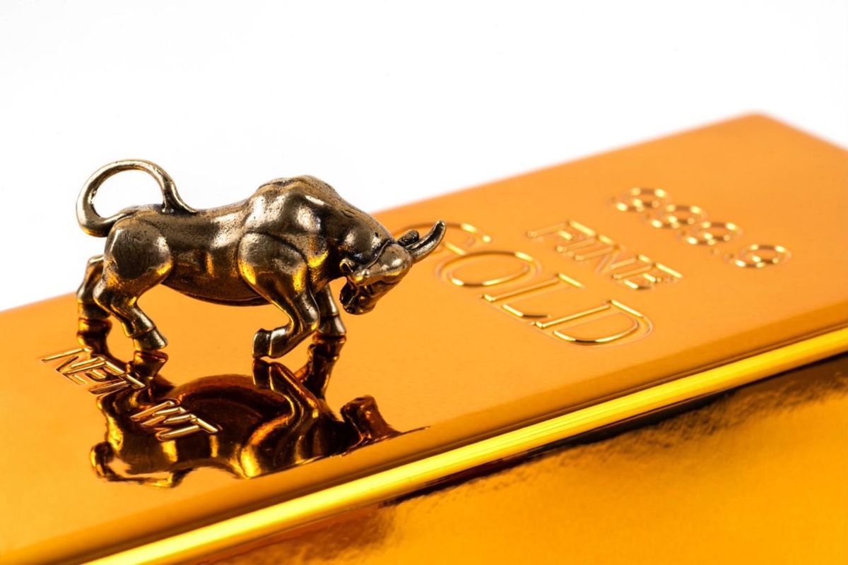 Bronze bull figurine on a gold bar.