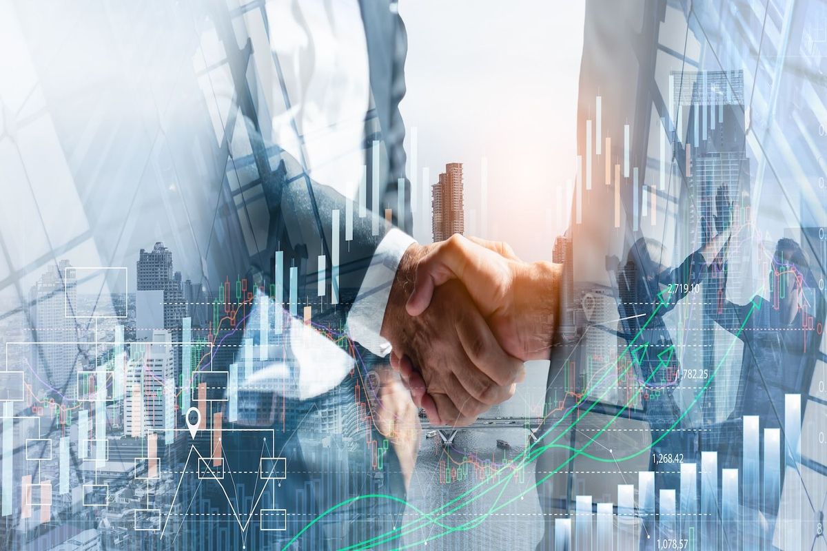 Business handshake with overlaid city skyline and stock market charts, symbolizing financial growth.