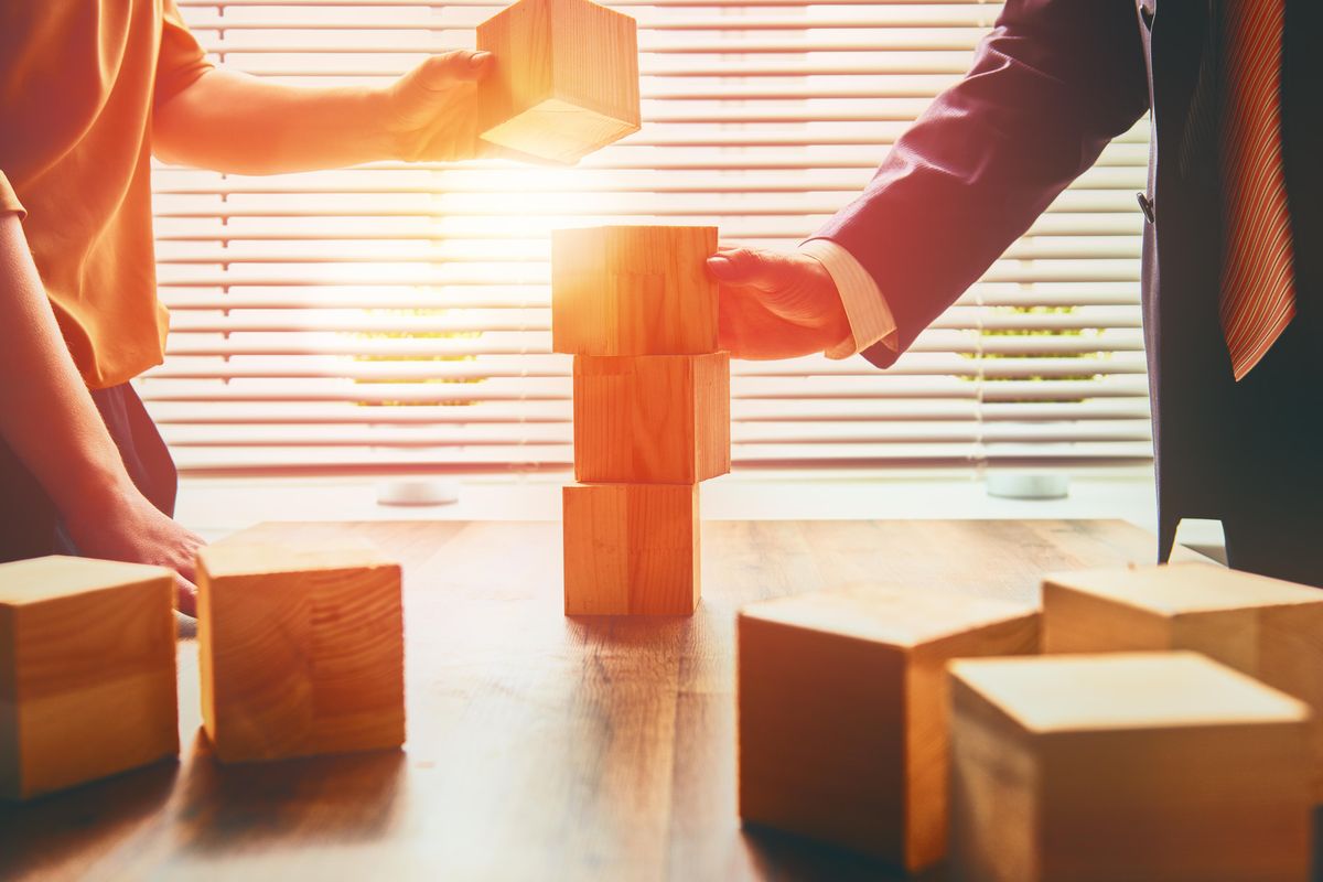 business people stacking blocks