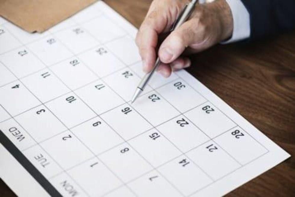 business person looking at calendar