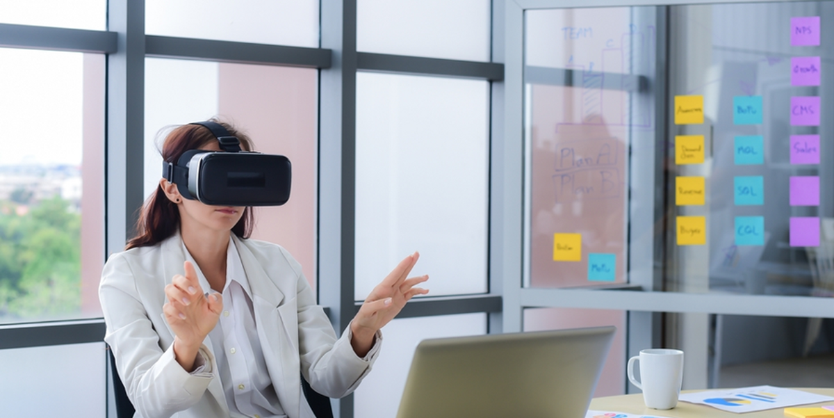 business person using a pair of vr goggles