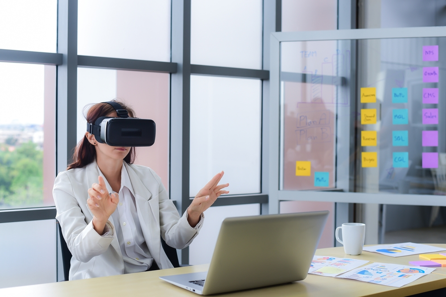 business person using a pair of VR goggles