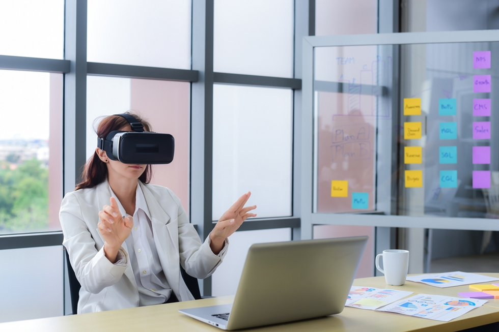 business person using a pair of vr goggles