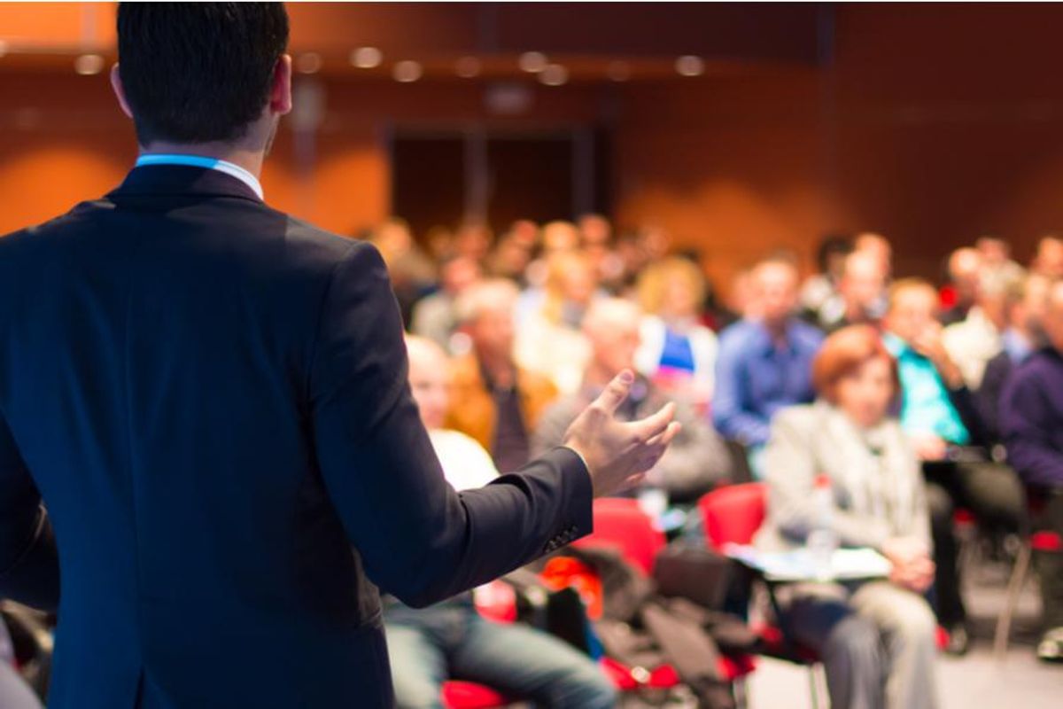 business speaker presenting to a conference room