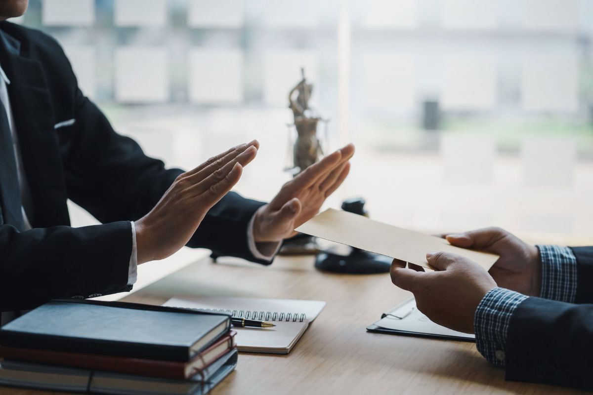 Businessman rejects deal paperwork.