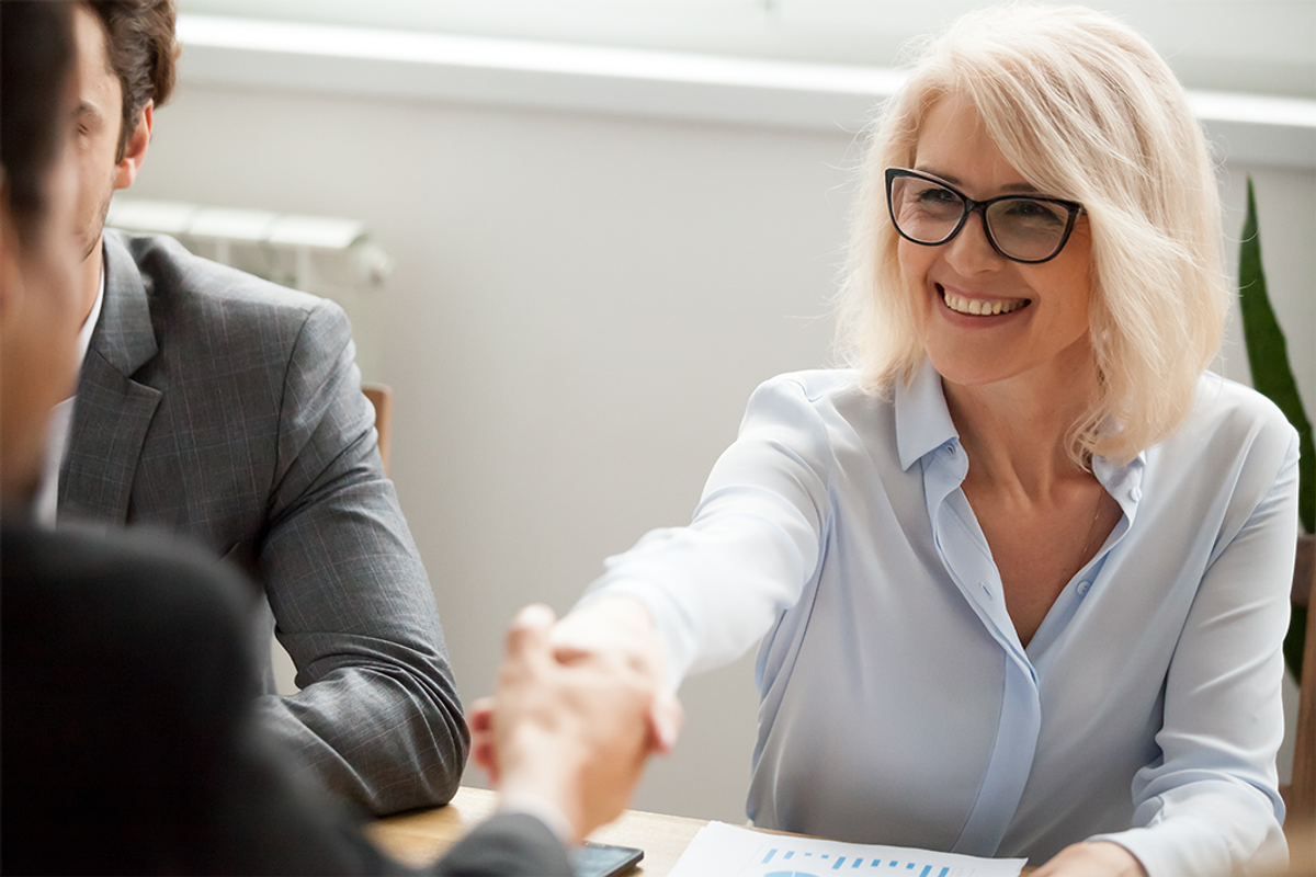 businesswoman shaking hands with businessman